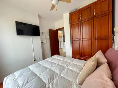 a bedroom with a bed and a flat screen tv at One-bedroom Apartment at Belvedere Holiday Club Complex in Bansko