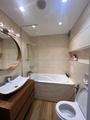 a bathroom with a tub and a sink and a toilet at The Mirror Apartment in Sofia