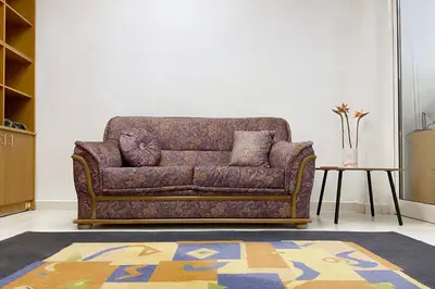 a brown couch in a living room with a table at Sofia Office Loft in Sofia
