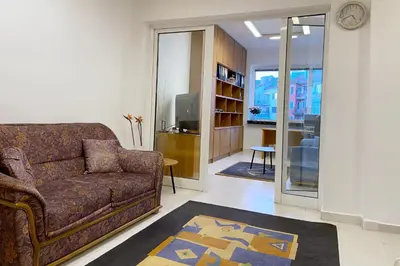 a living room with a couch and a tv at Sofia Office Loft in Sofia