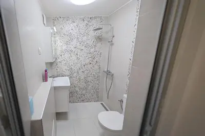 a white bathroom with a shower and a toilet at Sofia Office Loft in Sofia