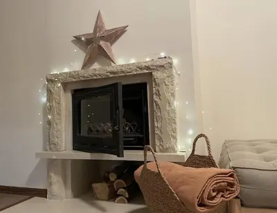 a living room with a fireplace with a star on the wall at Studio Béni in Smolyan