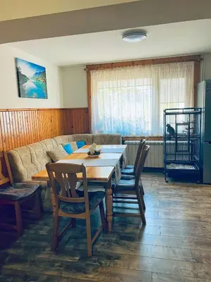 a living room with a table and chairs and a couch at Къща за гости Василеви in Bratsigovo