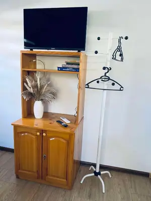 a room with a desk with a television and a lamp at Къща за гости Василеви in Bratsigovo
