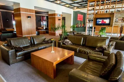 a lobby with leather couches and a coffee table at Pamporovo hotel Snezhanka A640 in Pamporovo