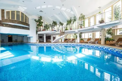 a large pool with blue water in a building at Pamporovo hotel Snezhanka A640 in Pamporovo