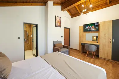 a bedroom with a bed and a desk at Lavalliere Hotel & Villas in Sarnitsa