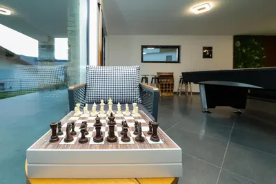 a chessboard in a living room with a couch and a table at Lavalliere Hotel & Villas in Sarnitsa