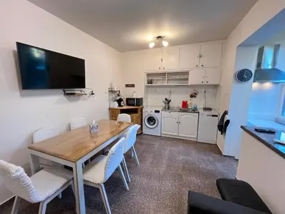a kitchen and dining room with a table and chairs at Glasgow 2BDR peaceful Apt 1 min from Metro w WiFi in Sofia