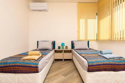 two beds sitting next to each other in a room at Two bedroom apt Karavelov with Private Parking Medical University in Plovdiv