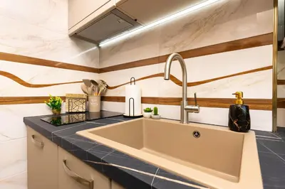 a kitchen with a sink and a counter top at Two bedroom apt Karavelov with Private Parking Medical University in Plovdiv