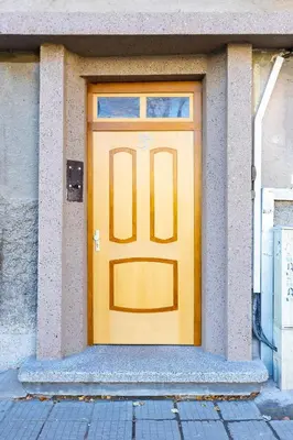 a yellow door on the side of a building at Tiny Secret Place next to MU with Private Parking in Plovdiv