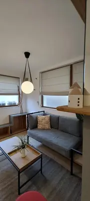 a living room with a couch and a table at Leaf apartment in Blagoevgrad