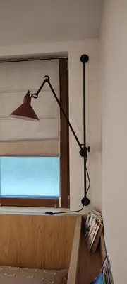 a living room with a lamp and a window at Leaf apartment in Blagoevgrad