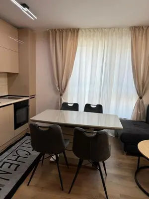 a living room with a white table and chairs at Патилови in Sandanski