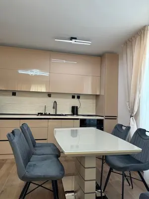 a kitchen with a white table and two chairs at Патилови in Sandanski