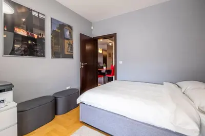 a bedroom with a bed and a chair in it at iLonka's Home 1 BDR with Workspace and Terrace in Sofia