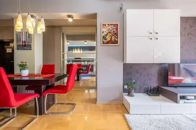 a living room with a dining table and red chairs at iLonka's Home 1 BDR with Workspace and Terrace in Sofia