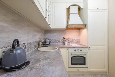 a kitchen with white cabinets and a pot stove at The EGO house at Vitoshka Street in Sofia