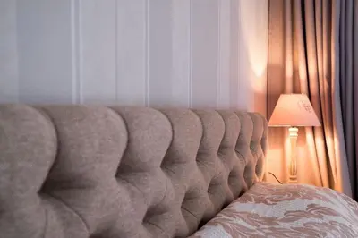 a couch sitting in a room with a lamp at The EGO house at Vitoshka Street in Sofia