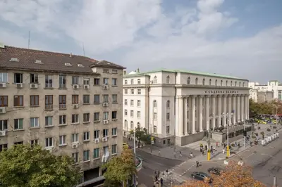 a group of buildings in a city with a street at The EGO house at Vitoshka Street in Sofia