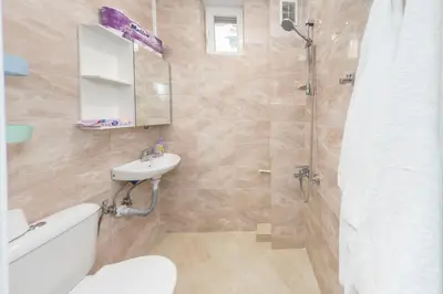 a bathroom with a shower and a toilet and a sink at Sofia Center - Vitoshka apartment in Sofia