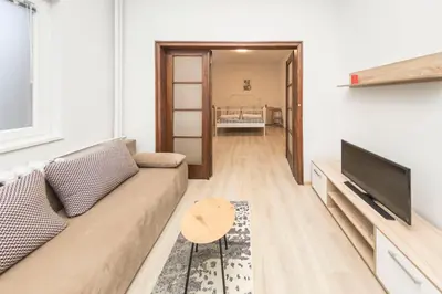 a living room with a couch and a tv at Sofia Center - Vitoshka apartment in Sofia