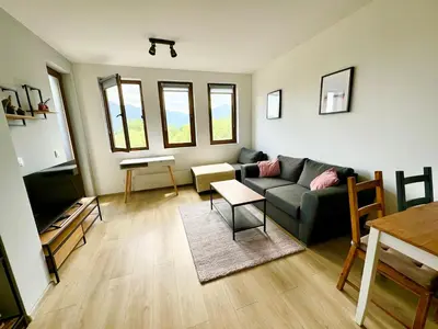a living room with a couch and a table at Хубавото място - Ski & Relax next to Pamporovo in Smolyan