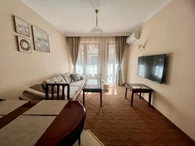 a living room with a couch and a table at Ski Lift - NoVi Apartments Bansko in Bansko