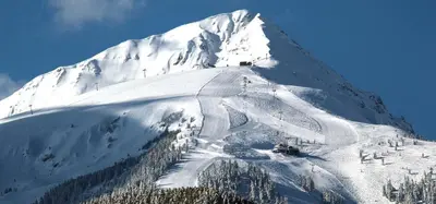 a snow covered mountain with a ski slope at Ski Lift - NoVi Apartments Bansko in Bansko