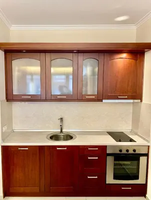 a kitchen with wooden cabinets and a sink at Ski Lift - NoVi Apartments Bansko in Bansko