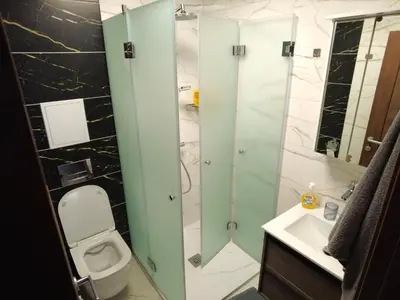 a bathroom with a toilet and a glass shower at 4-bedrooms luxury apartment very close to ski lift in Bansko