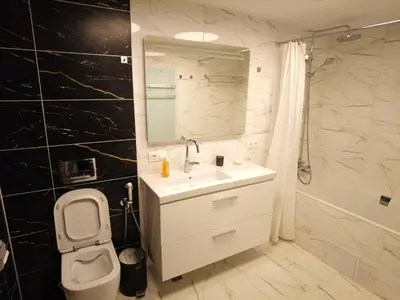 a bathroom with a sink and a toilet and a shower at 4-bedrooms luxury apartment very close to ski lift in Bansko