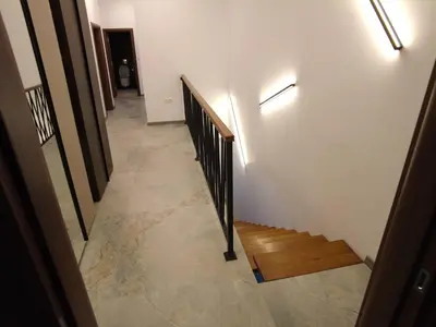 a hallway with a staircase and a stair railing at 4-bedrooms luxury apartment very close to ski lift in Bansko