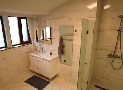 a bathroom with a sink and a shower at 4-bedrooms luxury apartment very close to ski lift in Bansko