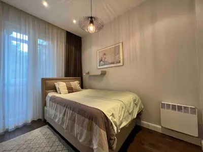 a bedroom with a bed in a room with a window at Perfectly Sumptuous Centre Apartment, 2-minute walk from Vitosha Boulevard in Sofia