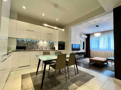 a kitchen and dining room with a table and chairs at Perfectly Sumptuous Centre Apartment, 2-minute walk from Vitosha Boulevard in Sofia