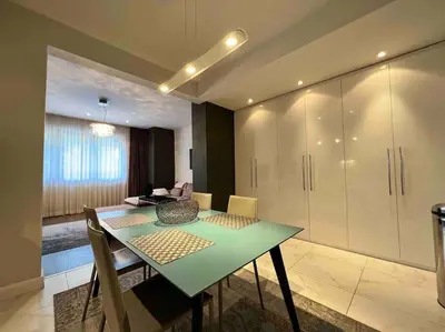 a dining room with a green table and chairs at Perfectly Sumptuous Centre Apartment, 2-minute walk from Vitosha Boulevard in Sofia