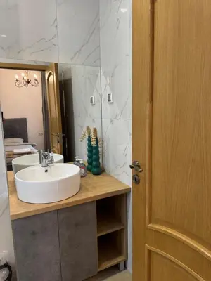 a bathroom with a sink and a mirror at Апартамент с двор Дива in Samokov