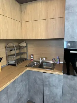 a kitchen with a sink and a microwave at Апартамент с двор Дива in Samokov
