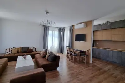 a living room with a couch and a table at Апартамент с двор Дива in Samokov