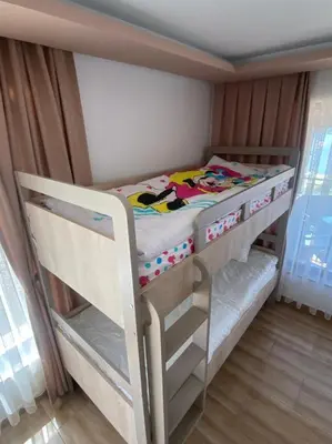 a small bedroom with a bunk bed in a room at Вила Сънсет 2 in Dospat