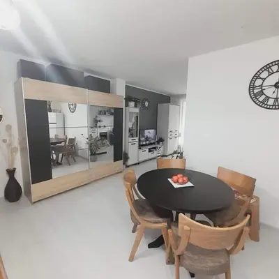 a kitchen and dining room with a table and chairs at lux apartament 88 in Bansko