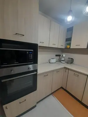 a kitchen with a stove and a microwave at lux apartament 88 in Bansko