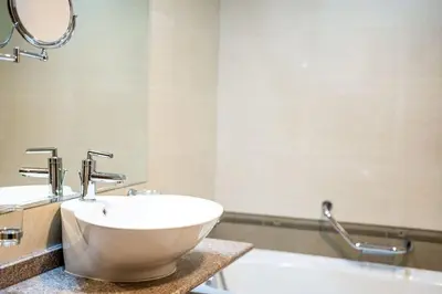 a bathroom with a bowl sink and a tub at Host2U Slope-Side Home by the Gondola in Bansko