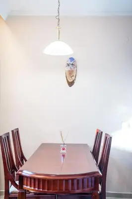 a dining room table with chairs and aendant light at Host2U Slope-Side Home by the Gondola in Bansko