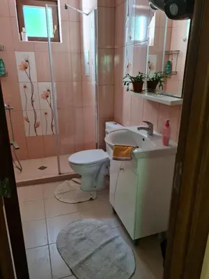a bathroom with a toilet and a sink and a shower at South Park apartment free parking near Tokuda in Sofia