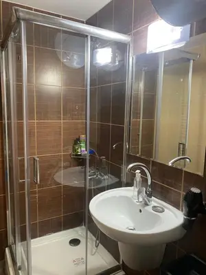 a bathroom with a shower and a sink and a shower at Bansko Royal Towers Apartment - top location in Bansko