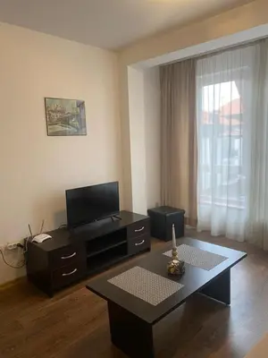 a living room with a tv and a coffee table at Bansko Royal Towers Apartment - top location in Bansko