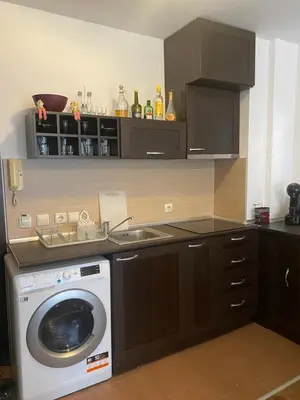 a kitchen with a washing machine and a sink at Bansko Royal Towers Apartment - top location in Bansko